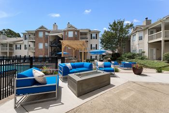 Poolside fire pit and lounge at Chace Lake Villas apartments for rent